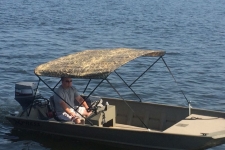 3-Bow Round Tube Bimini Top - Camo Series, Mossy Oak Shadow Grass pattern w/Black Matte Frame on a Xpress Boat.